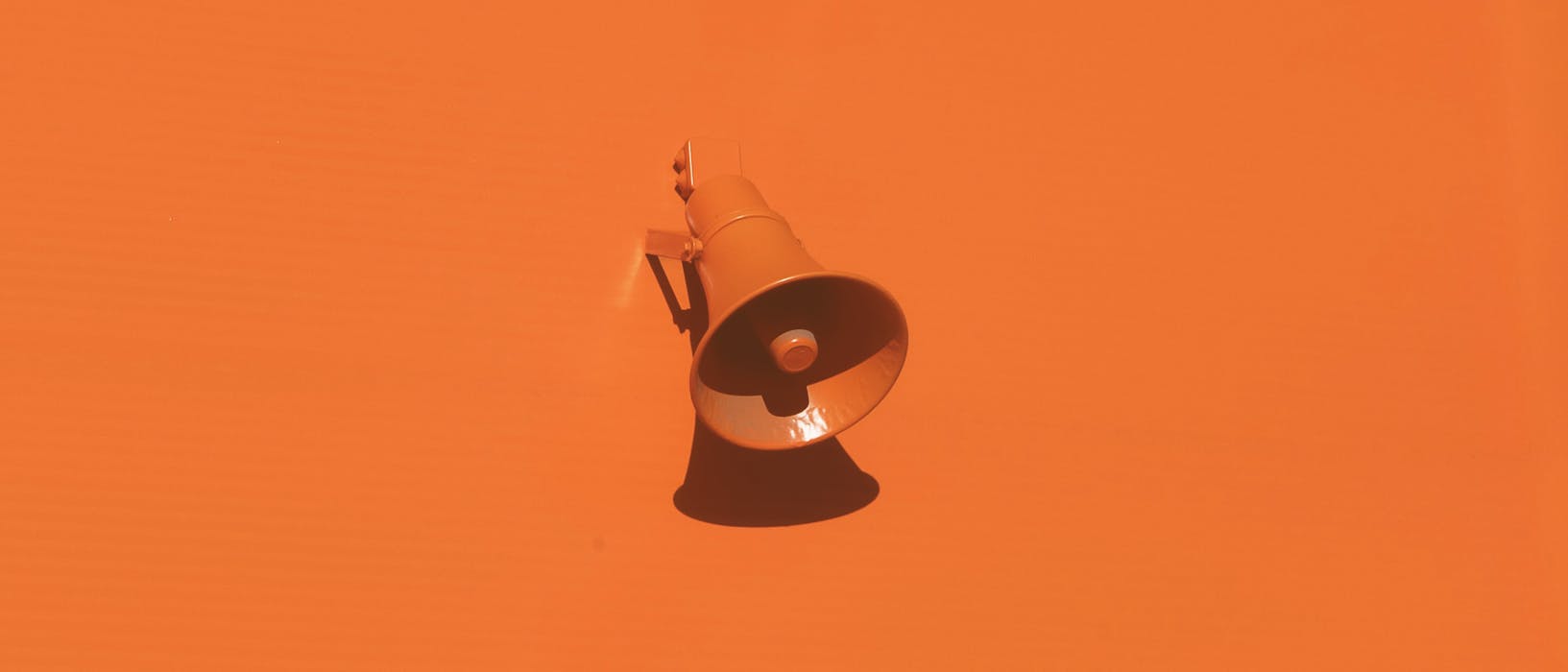 orange megaphone on orange wall