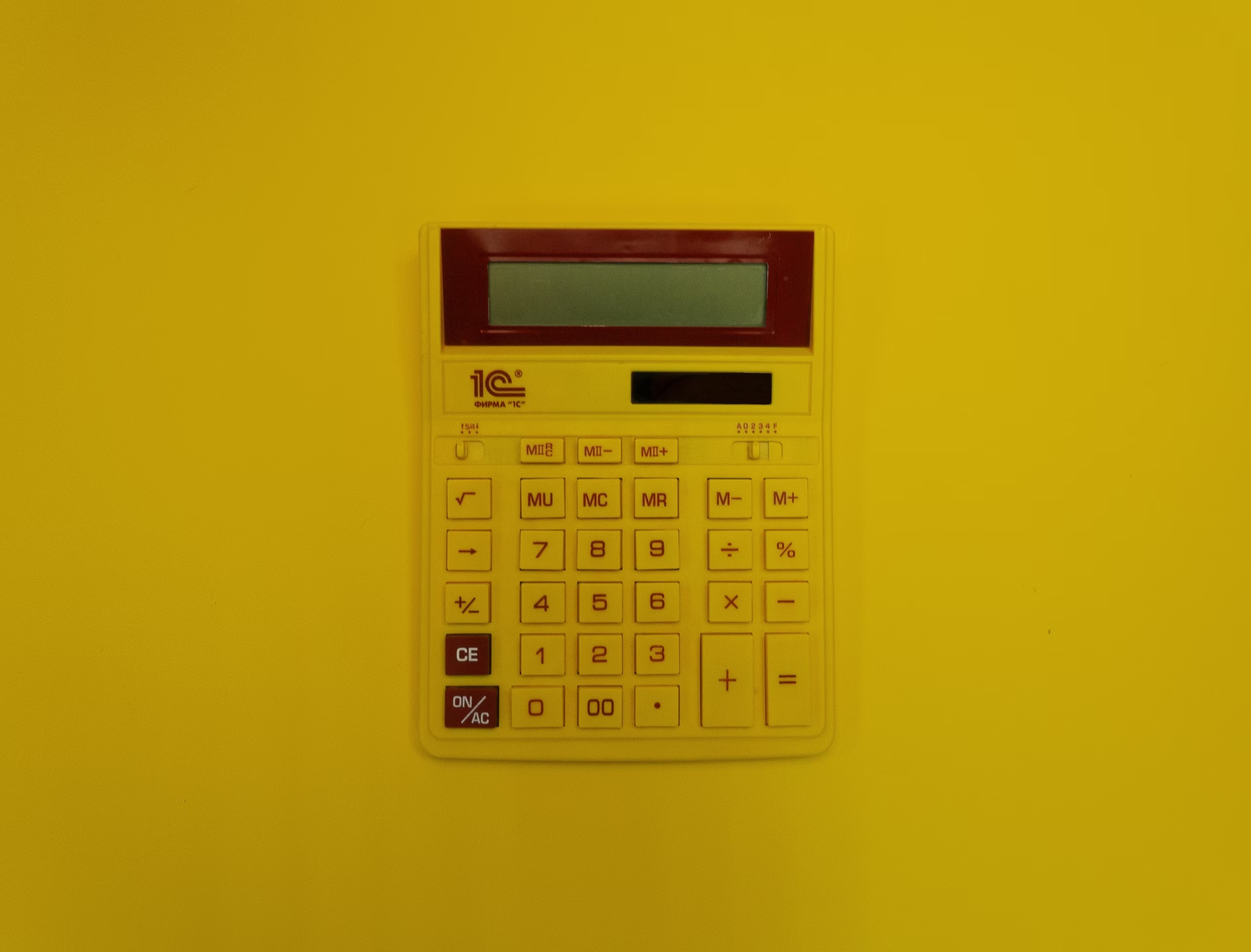 A calculator on a yellow background