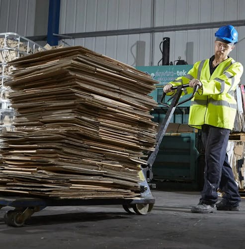 A Wastecare employee moving items to be recycled