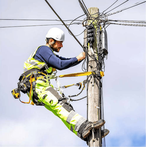 A Heneghan engineer fixing a telegraph pole