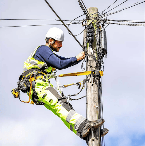 A Heneghan engineer fixing a telegraph pole