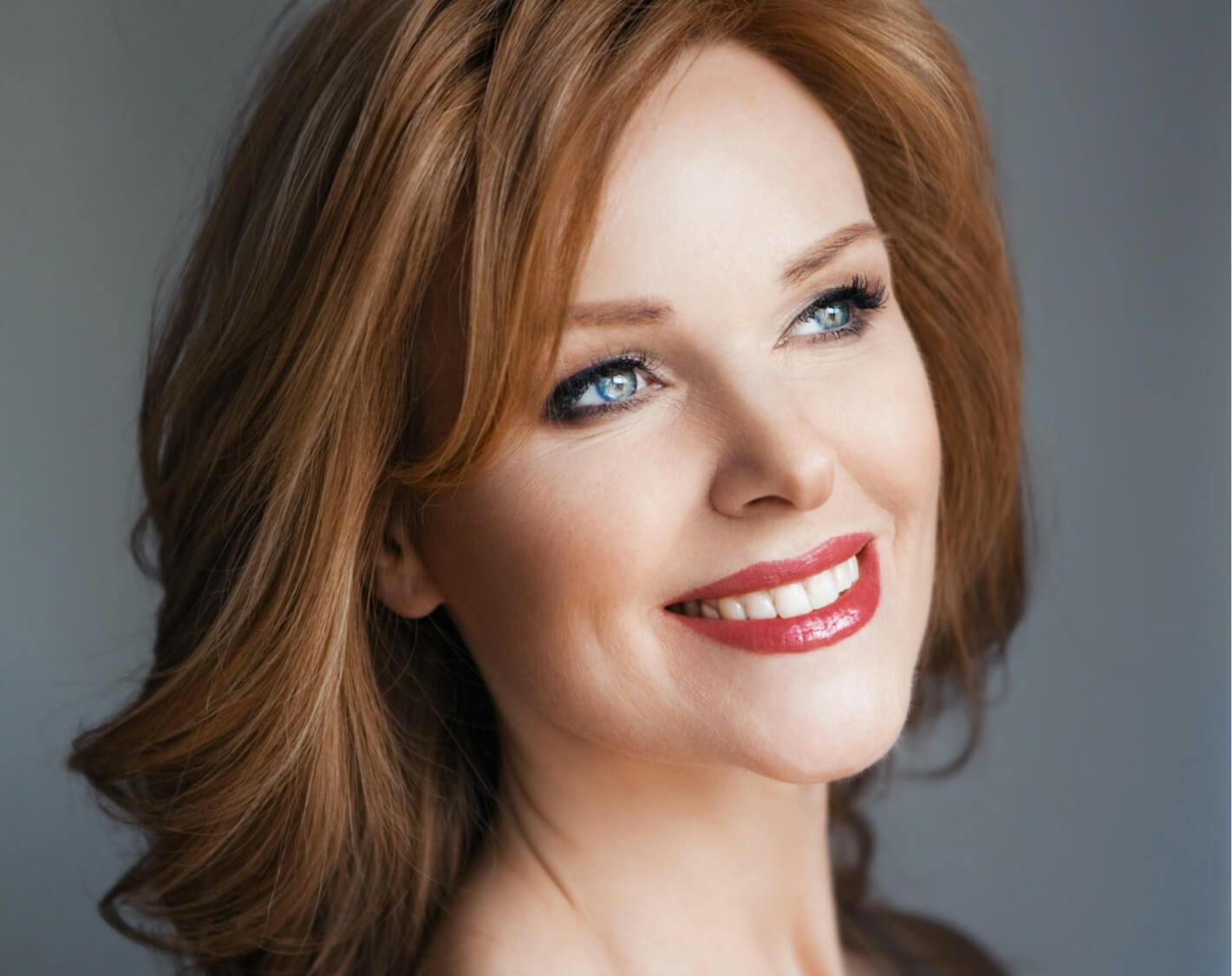 Woman with glowing skin and a lovely smile.