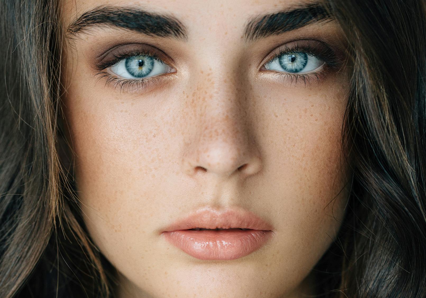 Close up on woman's face with beautiful skin and stunning eyes.