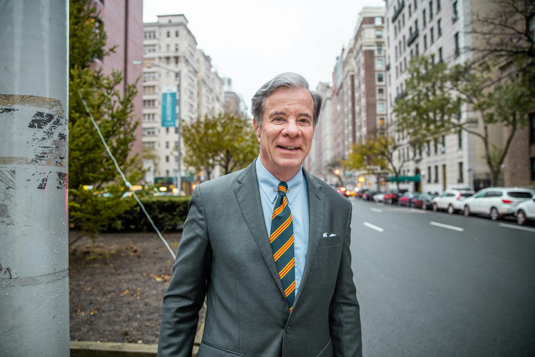 Dr. Antell in a suit and tie standing on a city street