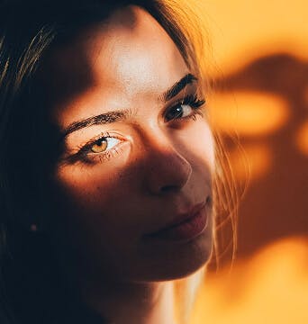 woman with light shining on her face