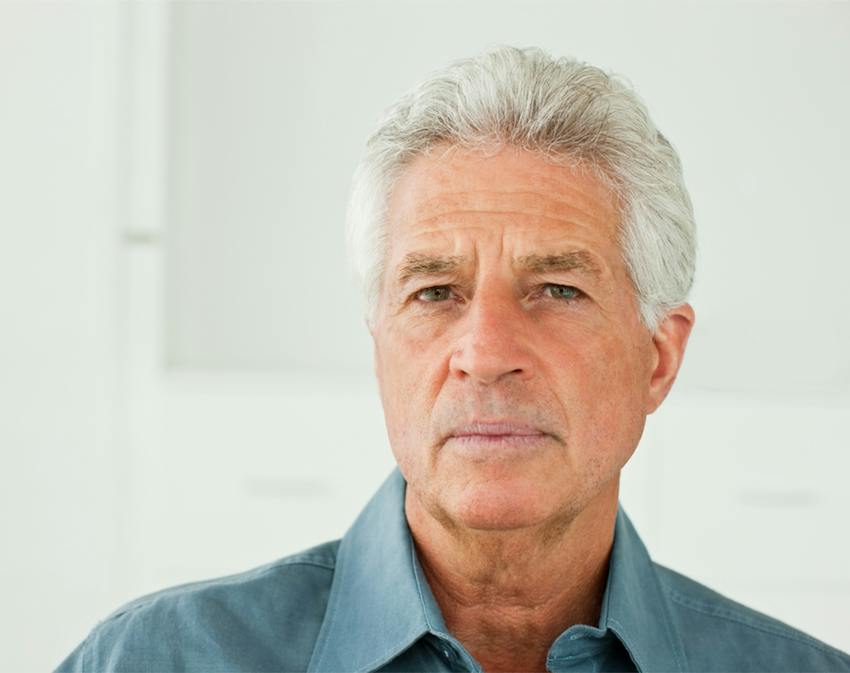 older man looking into the camera