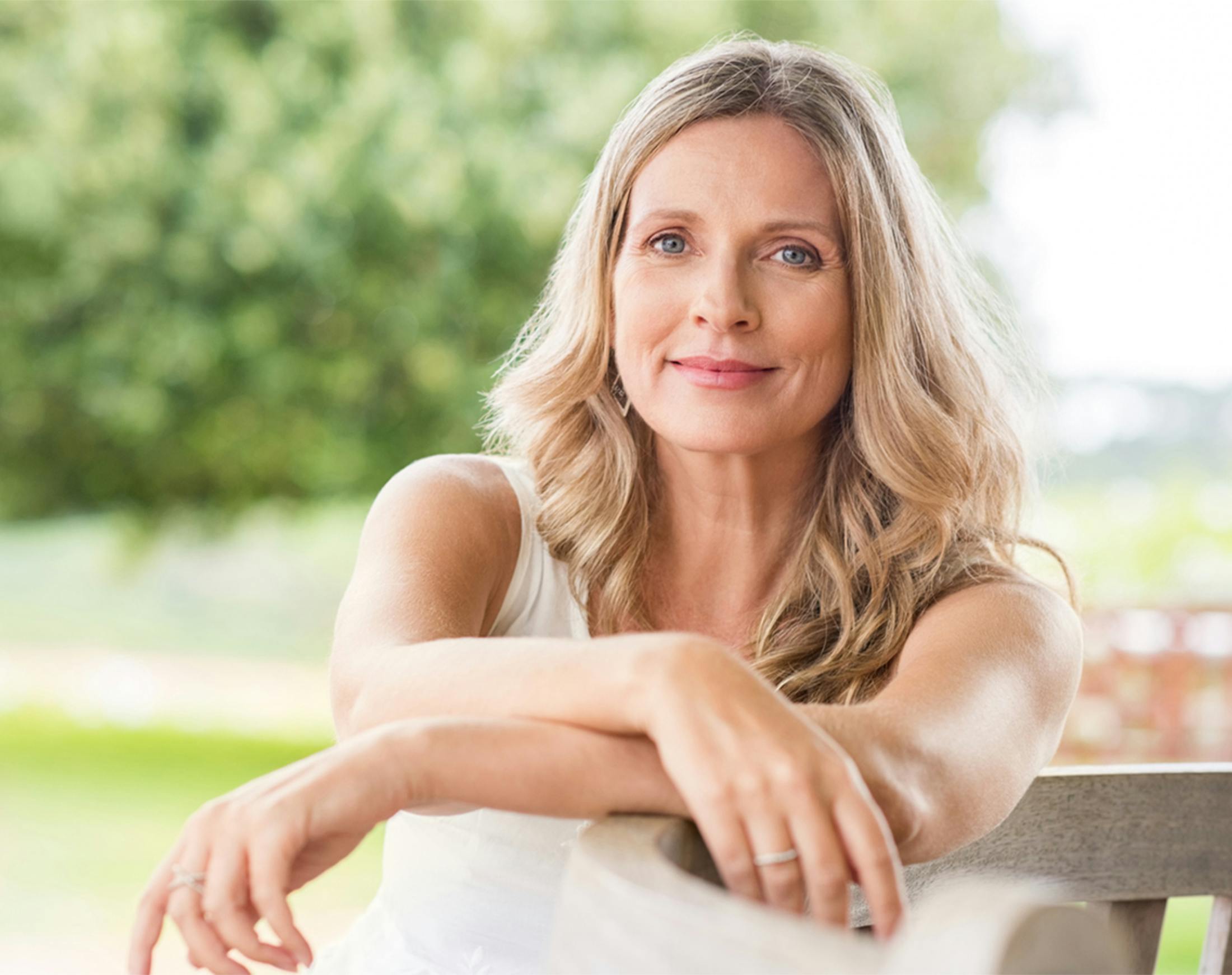 woman leaning against a bench