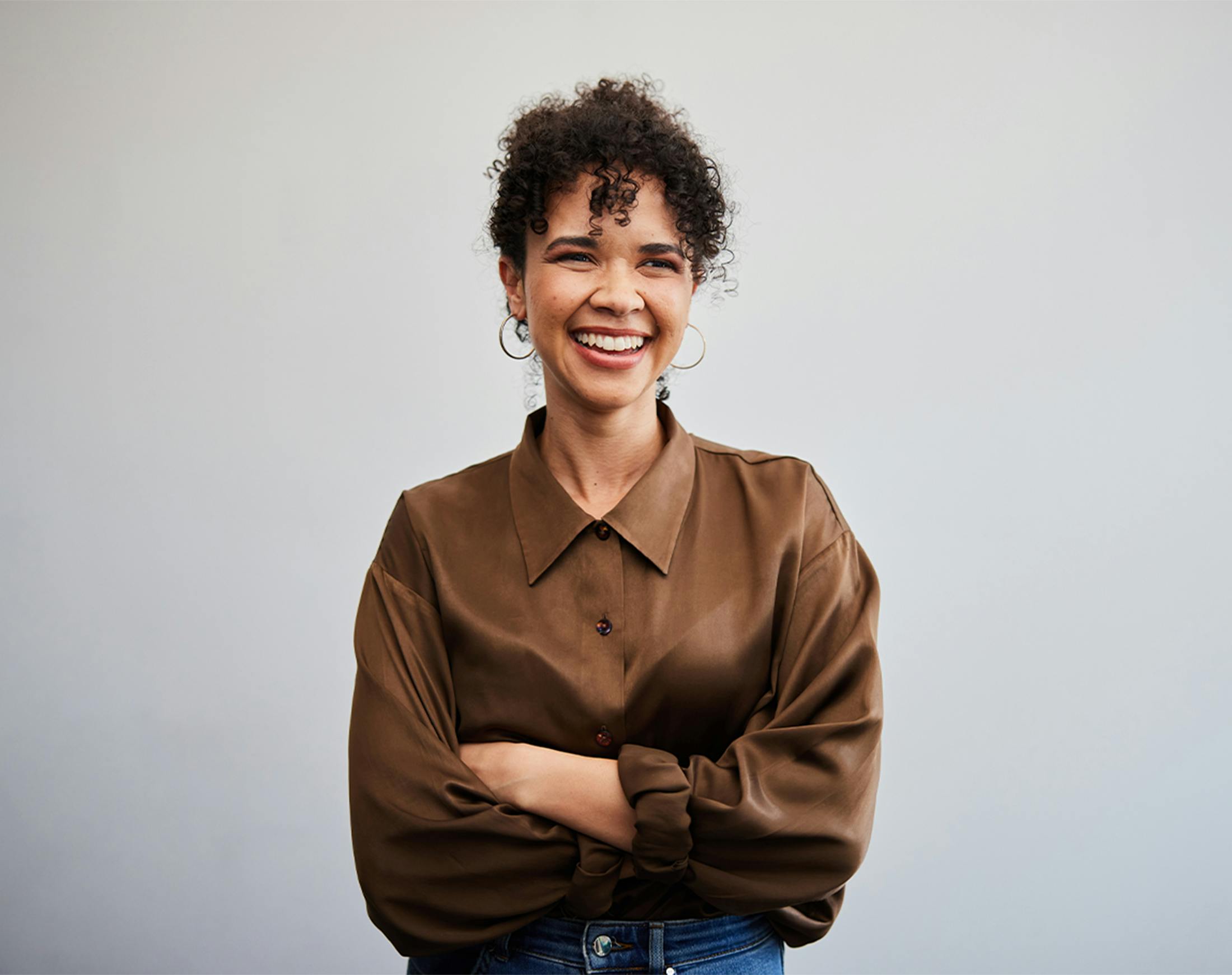 woman smiling, crossing her arms