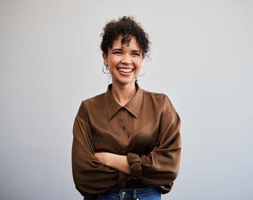 woman smiling, crossing her arms