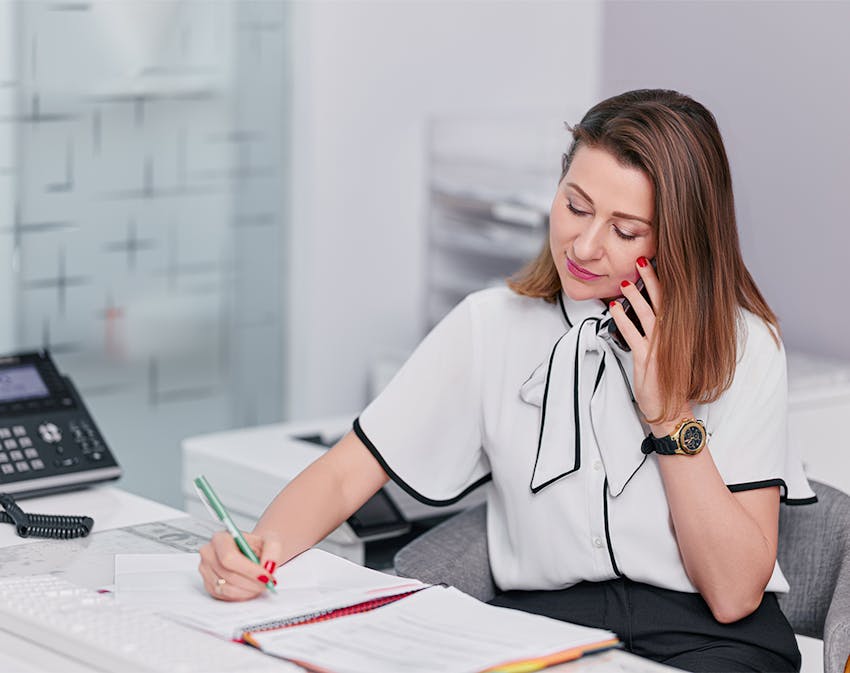 woman writing on paperwork