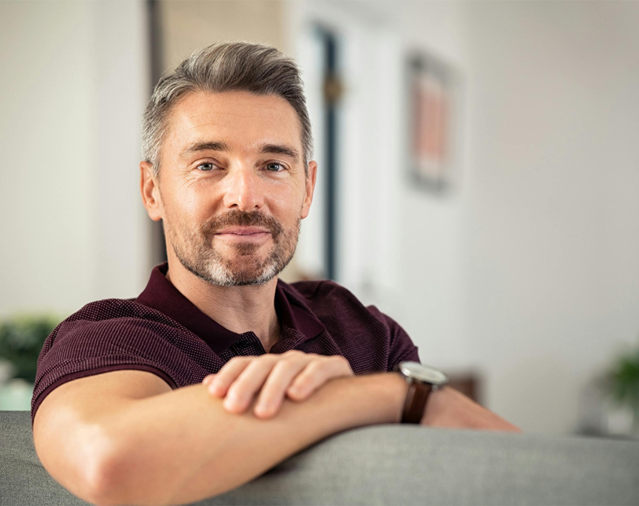 man leaning against the back of a couch