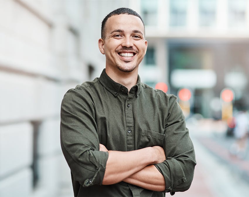 smiling man crossing his arms