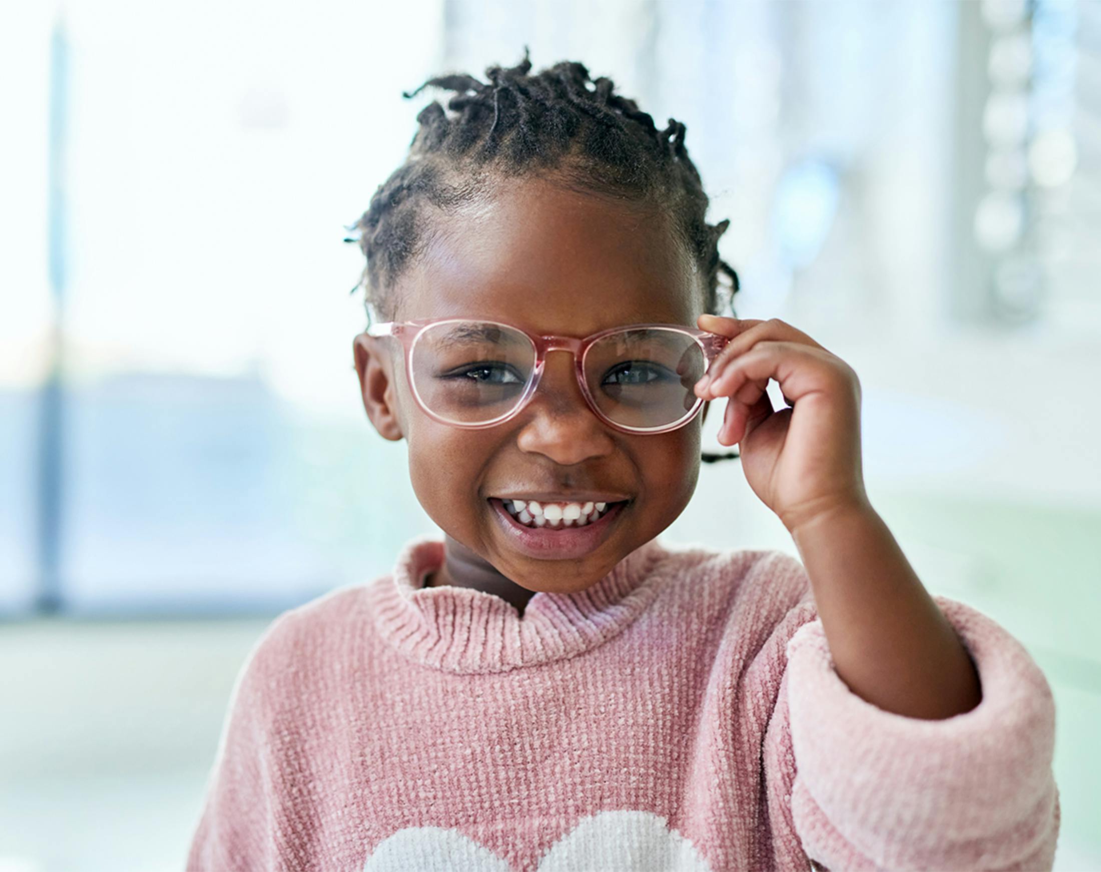 young girl grabbing her glasses