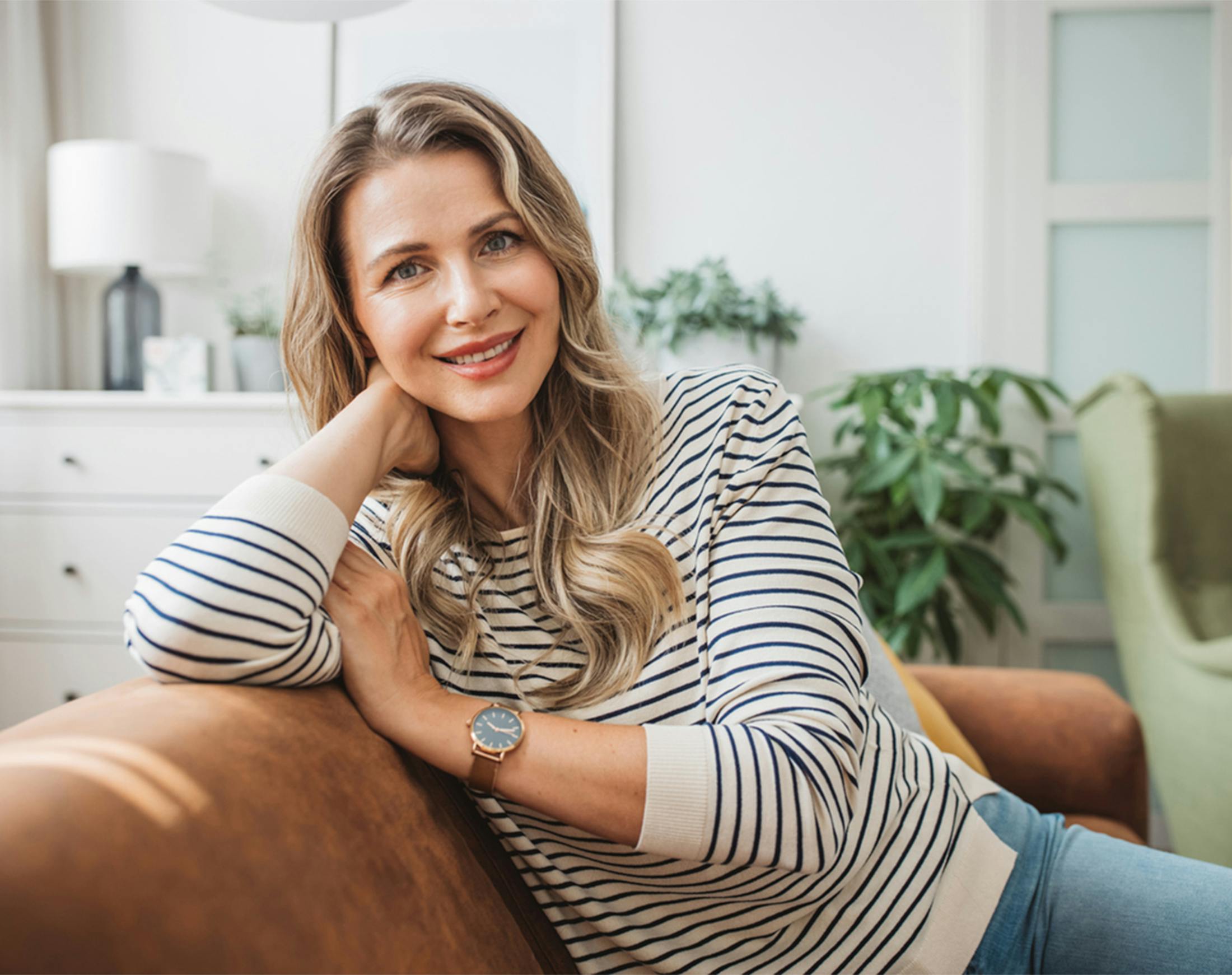 woman leaning on the back of a couch