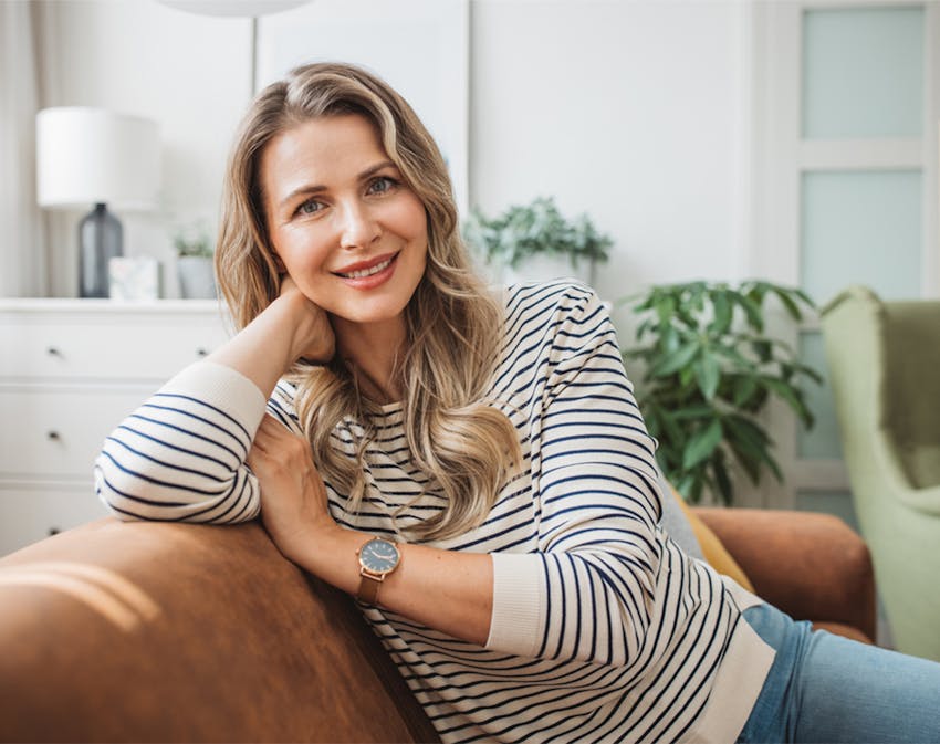 woman leaning on the back of a couch