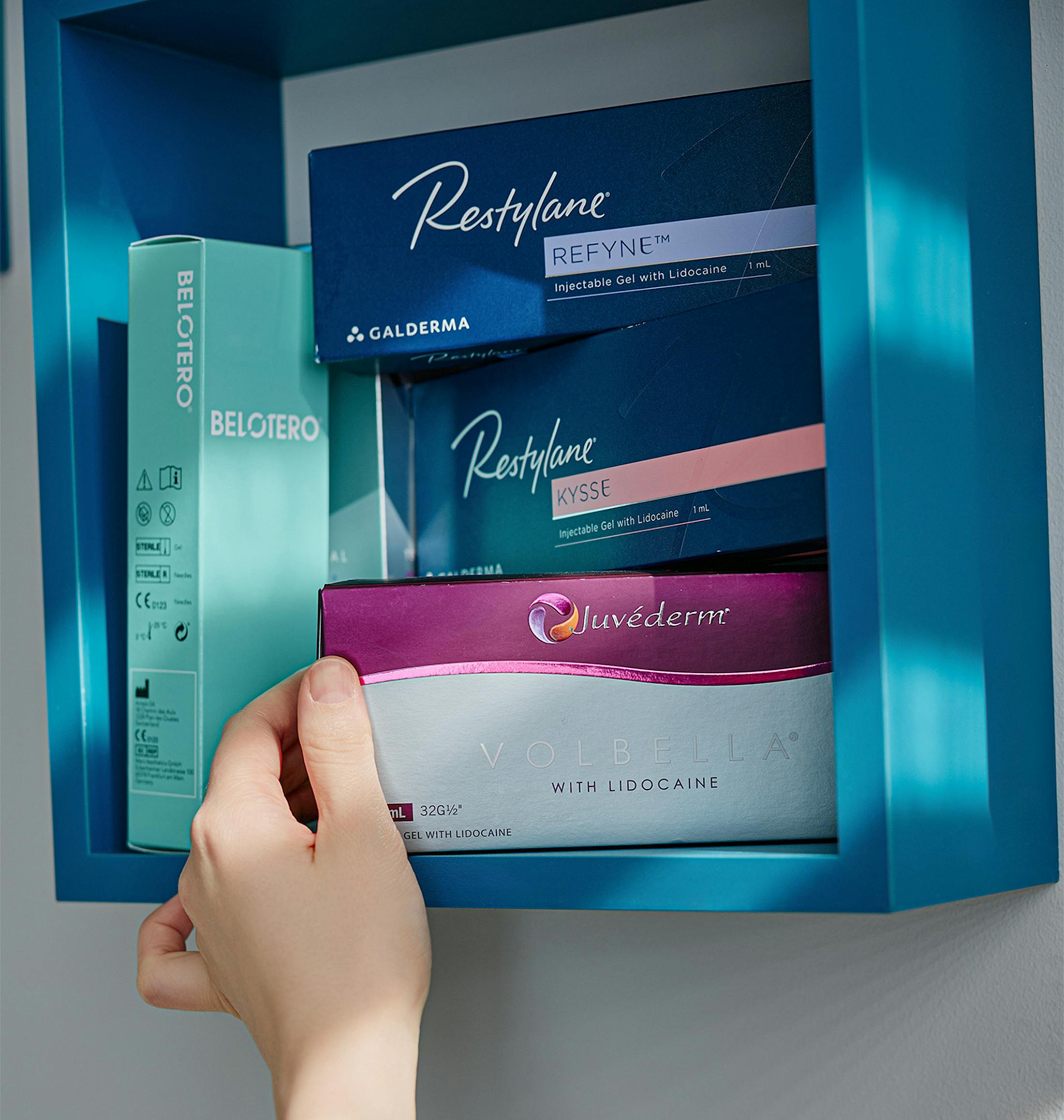 person grabbing a box of Juvederm