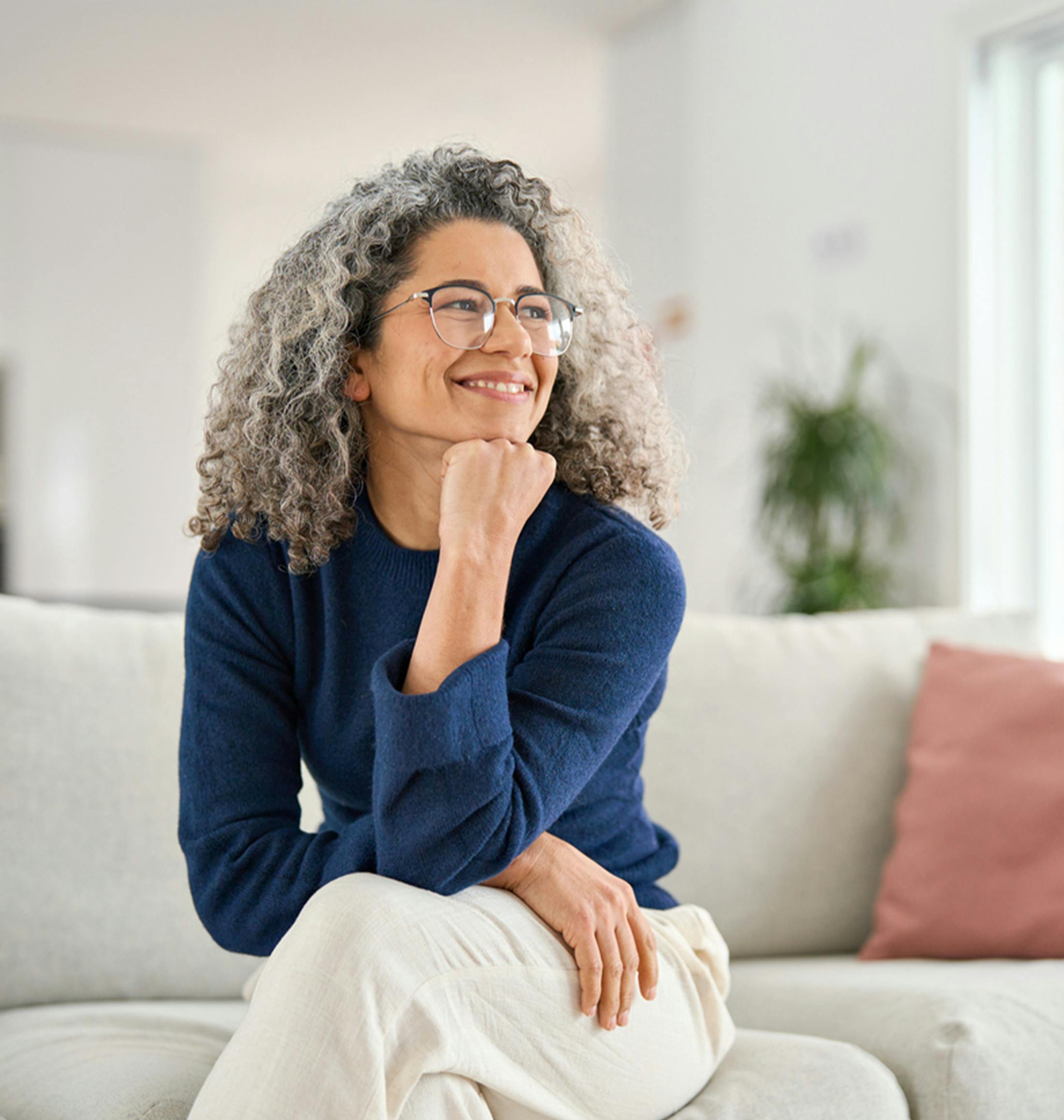 older woman resting her head on her hand