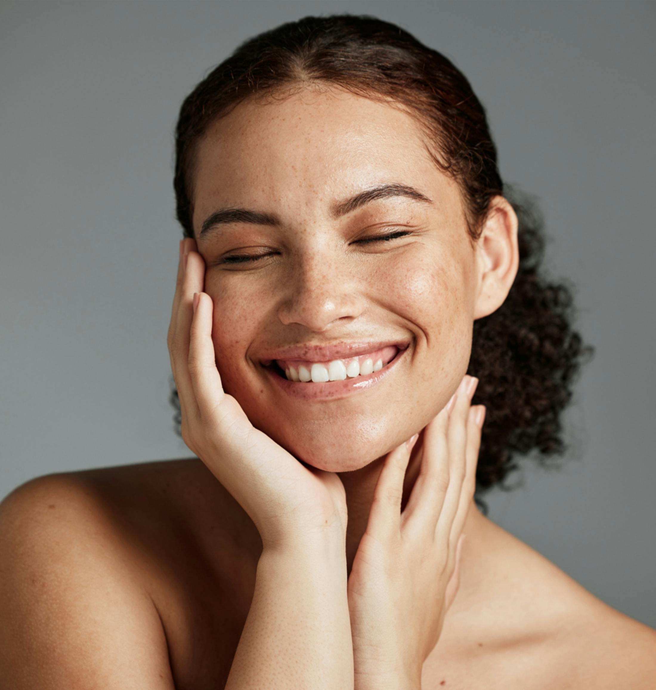 smiling woman touching her face