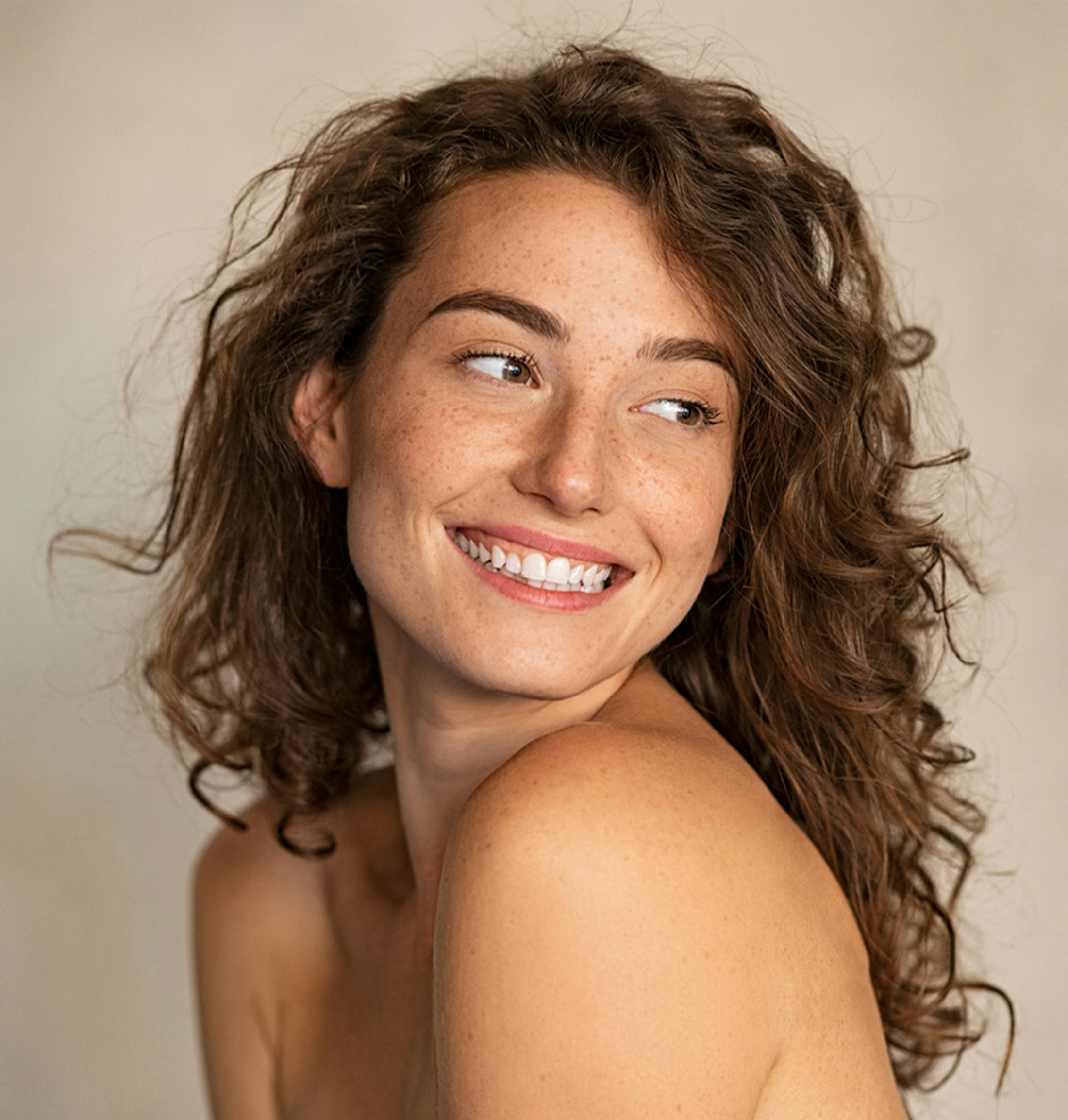woman smiling over her shoulder