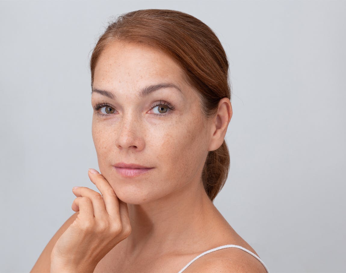 woman touching her face