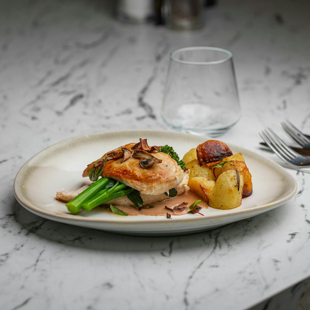 Chicken breast with a mushroom sauce, broccolini and roasted potatoes