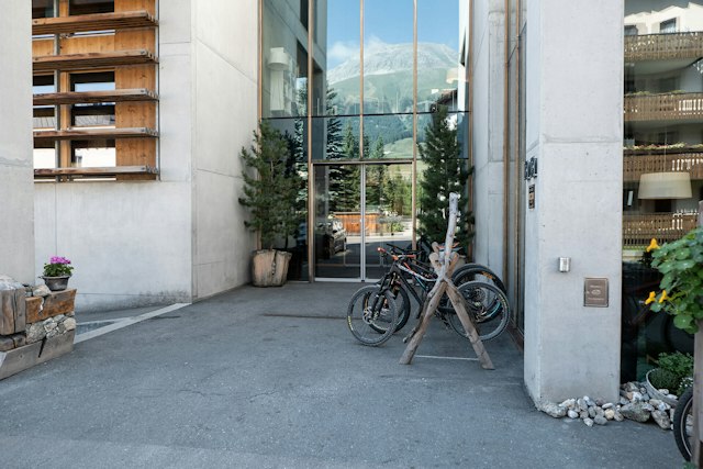 Eingang des ALL IN ONE HOTEL INN LODGE im Sommer mit Mountainbike an Bikeständer.
