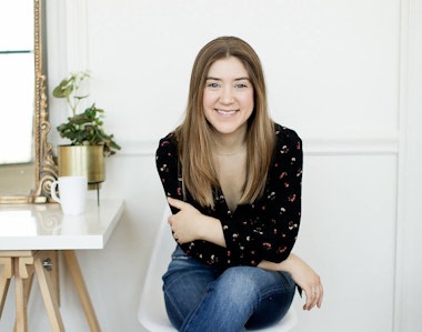 Megan Tantillo, sitting and smiling