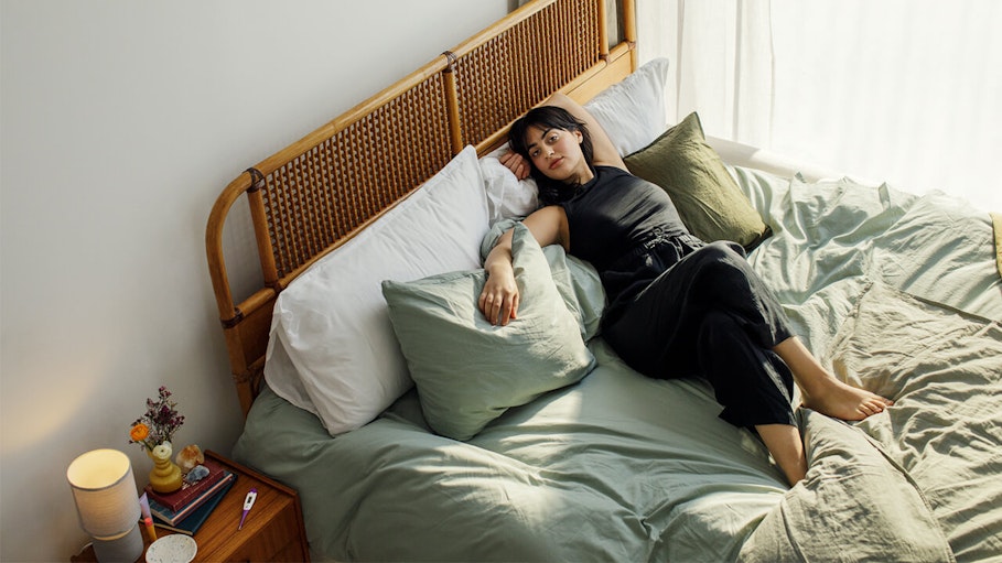 Woman lying on bed looking relaxed