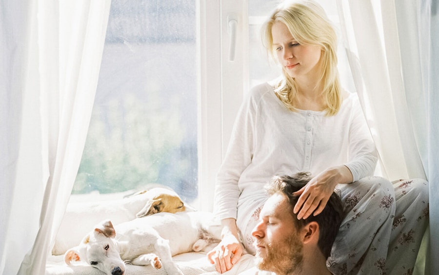 Couple with two dogs sitting in the window