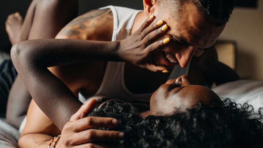 Couple on bed smiling