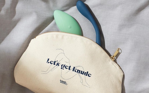 2 vibrators peeking out of a bag with 'Let's get knude' written on it