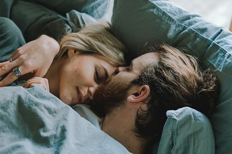 Couple cuddling in bed