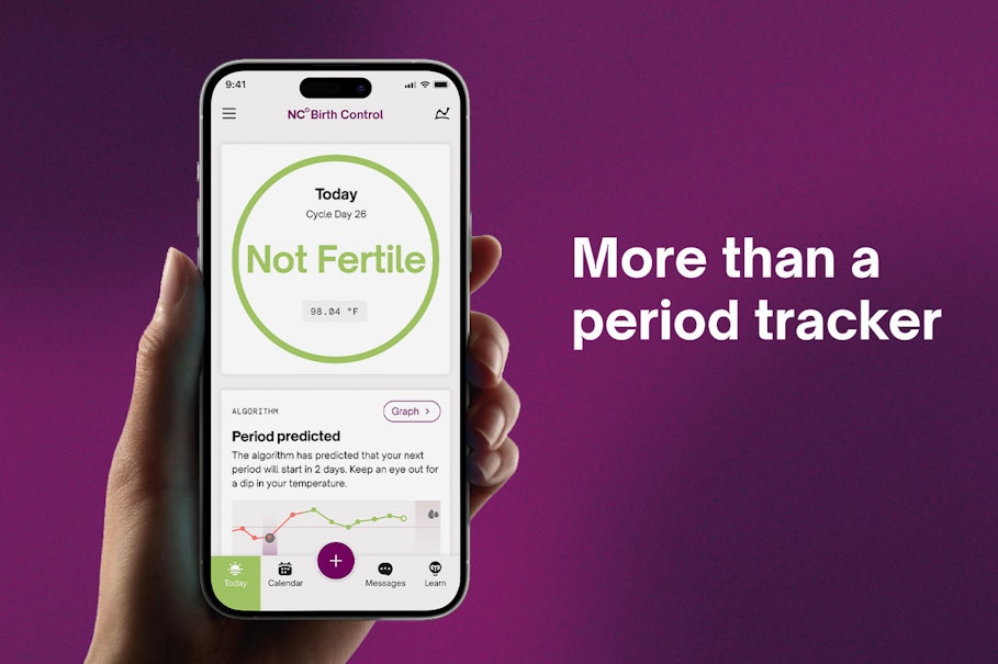 Hand holding up Natural Cycles phone screen with the text 'not a period tracker'