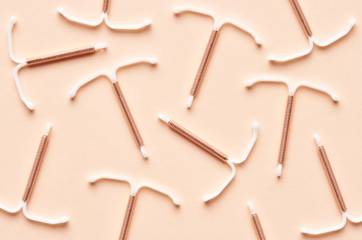 A number of copper IUDs on a table
