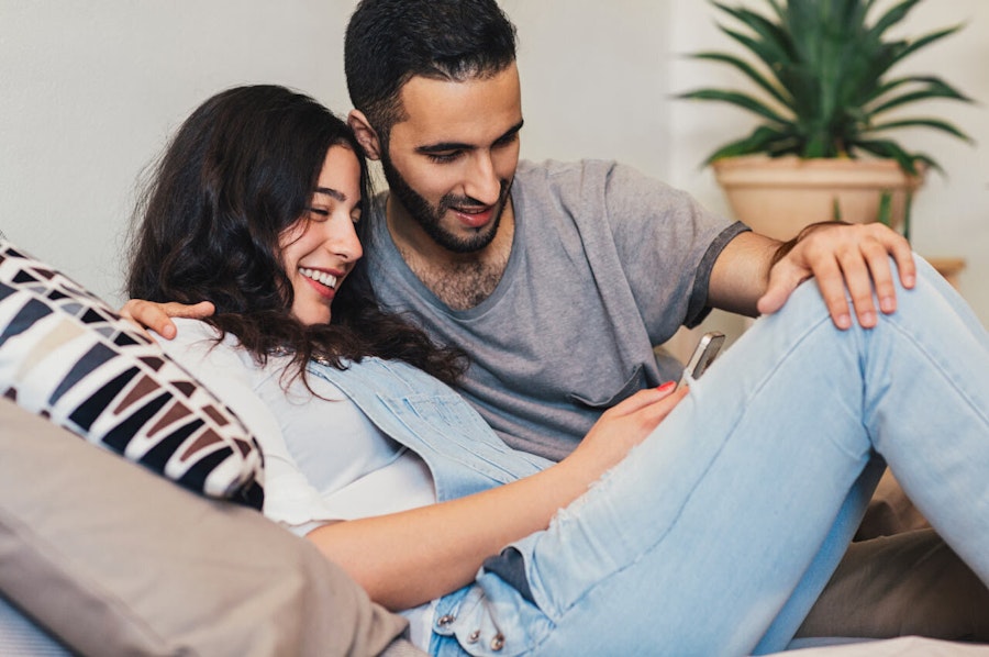 Couple looking at a phone smiling