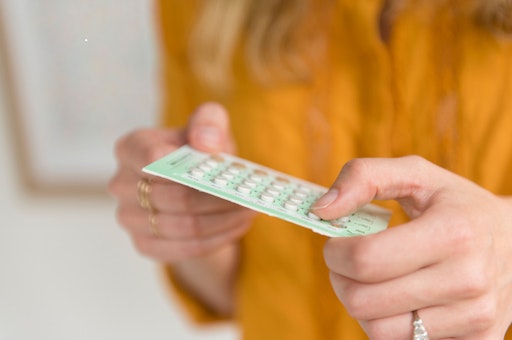 Woman's hands holding a pack of birth control pills