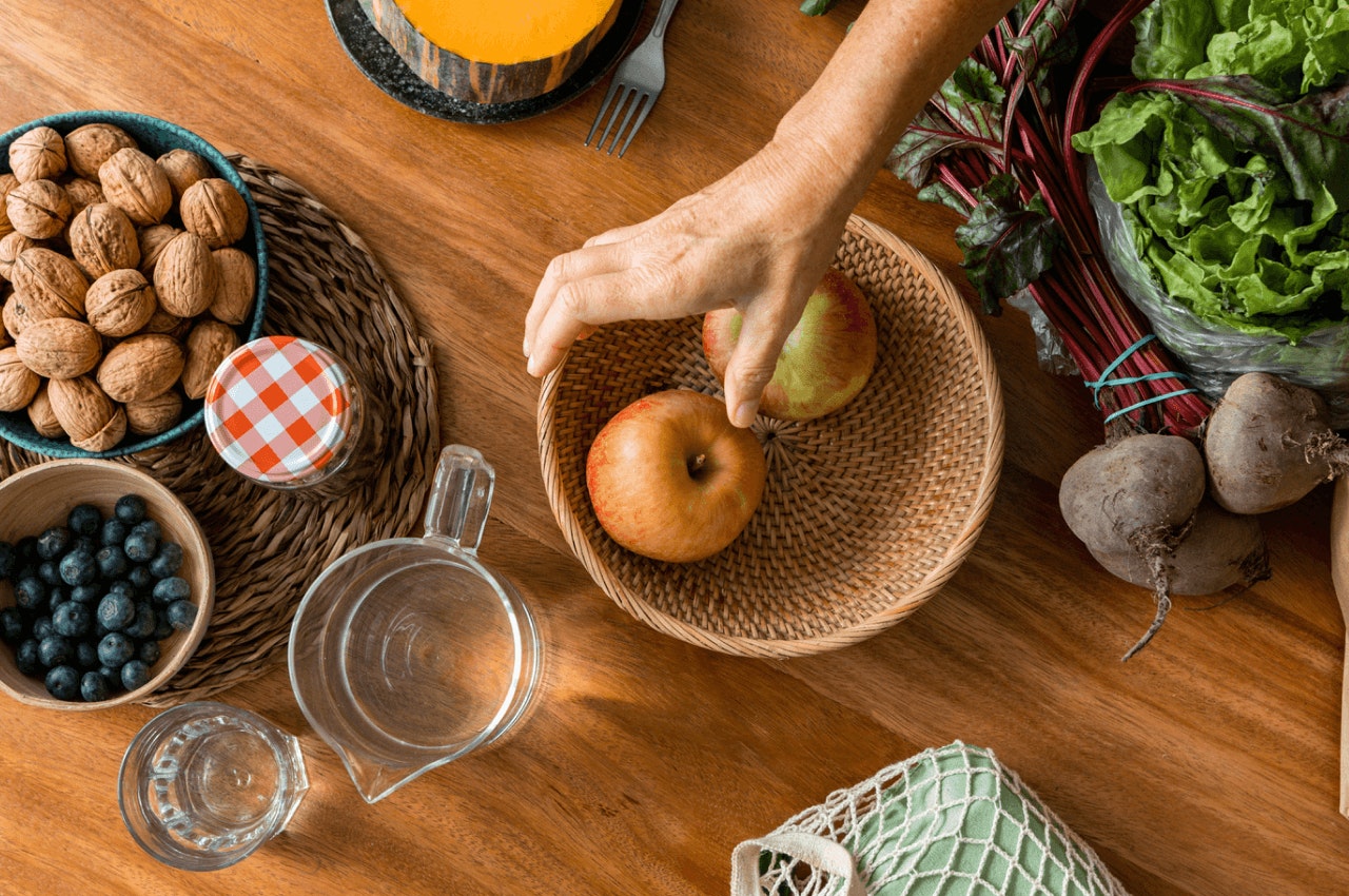 Photograph of apples and nuts on a wooden table