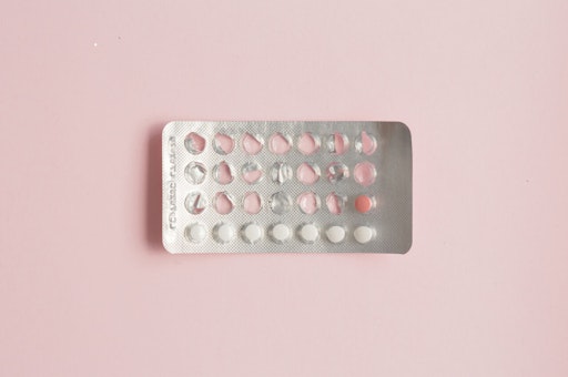 Photograph of a packet of birth control pills with only a few pills left in the packet