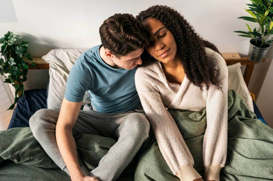 Couple sat in bed