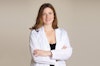 Dr Krauss wearing a white coat with her arms folded