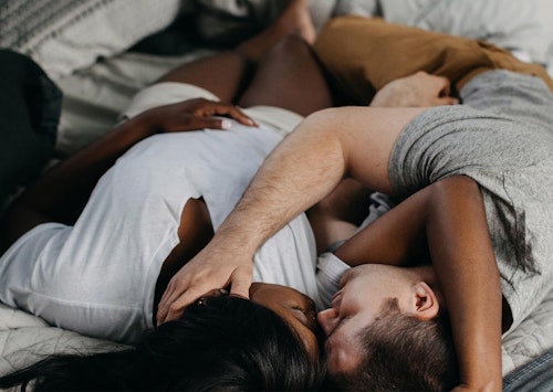 Couple lying in bed embracing