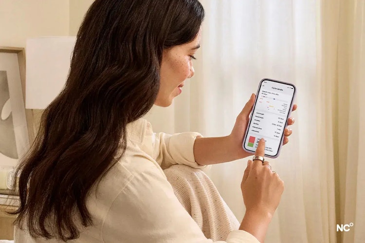 Woman looking at an app screen on her mobile phone