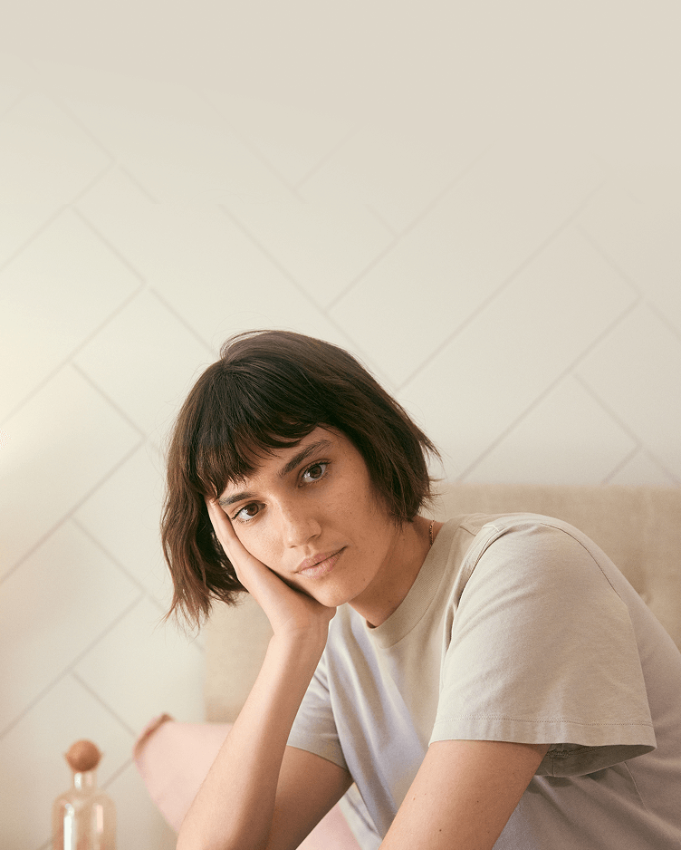girl with hand holding face in bed mobile