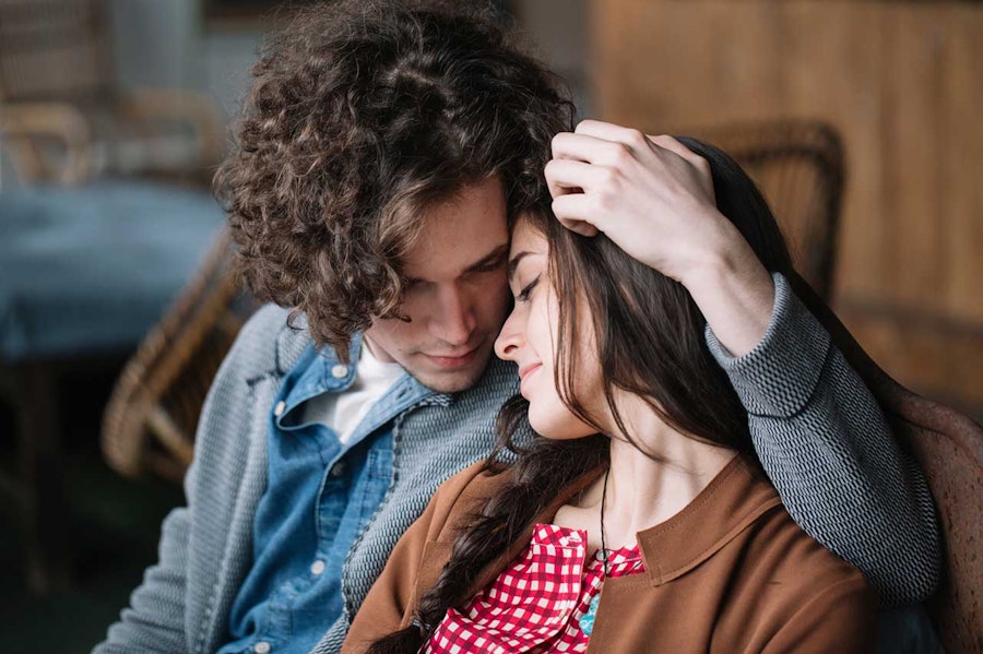 Young couple sitting cuddled into each other