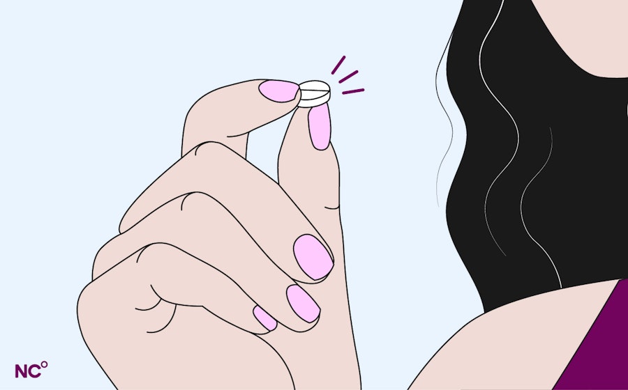 Woman holding up emergency pill