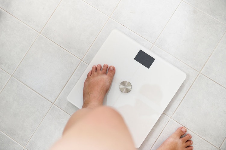 Women stepping onto a scale
