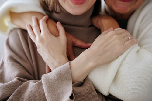 Two women of two different generations holding each other
