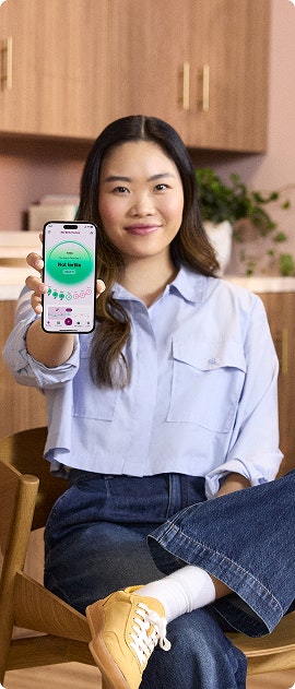 woman showing app in phone