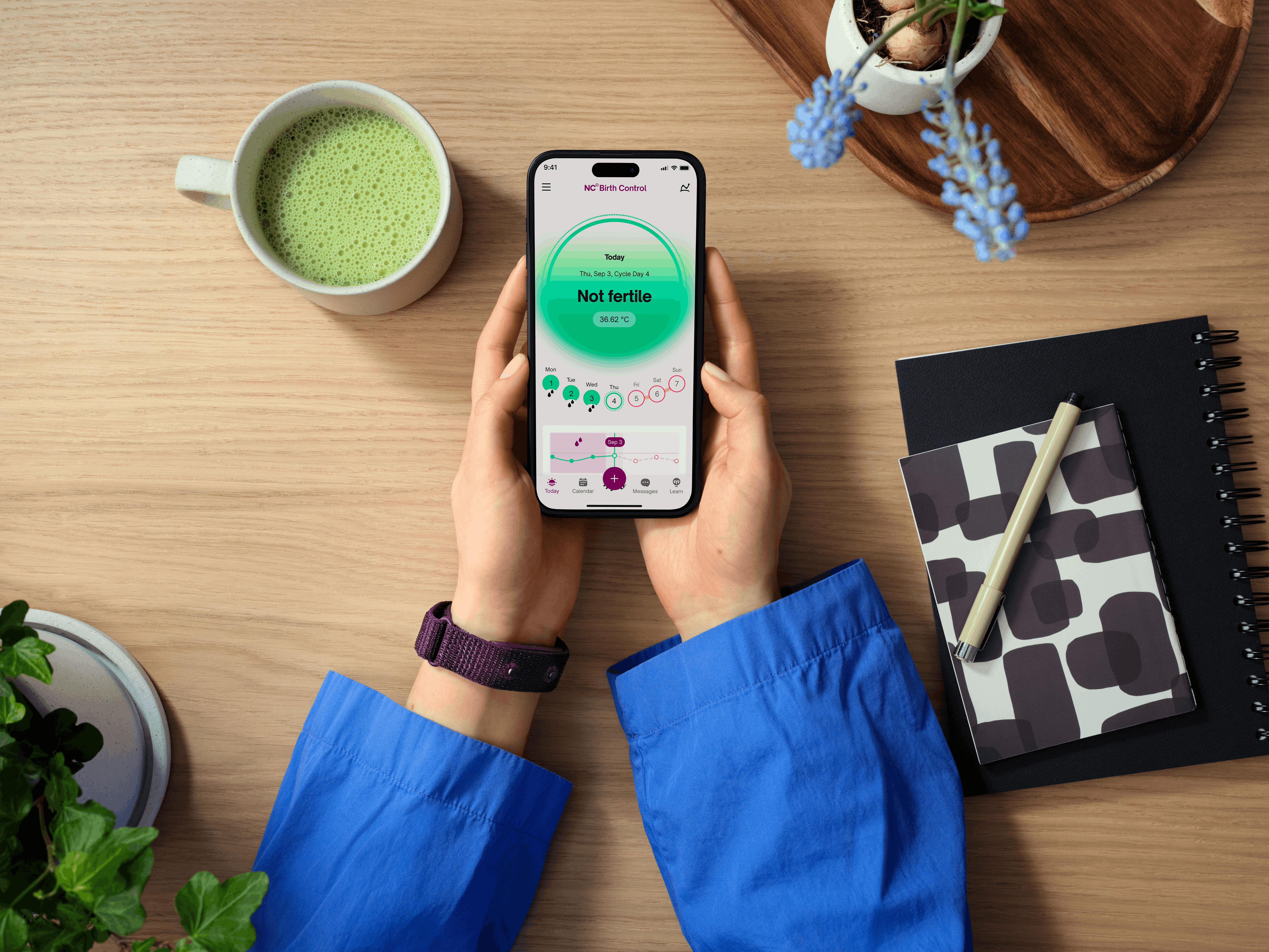 Woman holding phone with wearable band and phone screen reads Not Fertile Woman holding phone with wearable band and phone screen reads Not Fertile