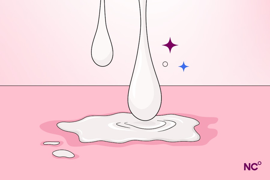 White liquid dripping onto a pink background with some purple and blue stars in the background